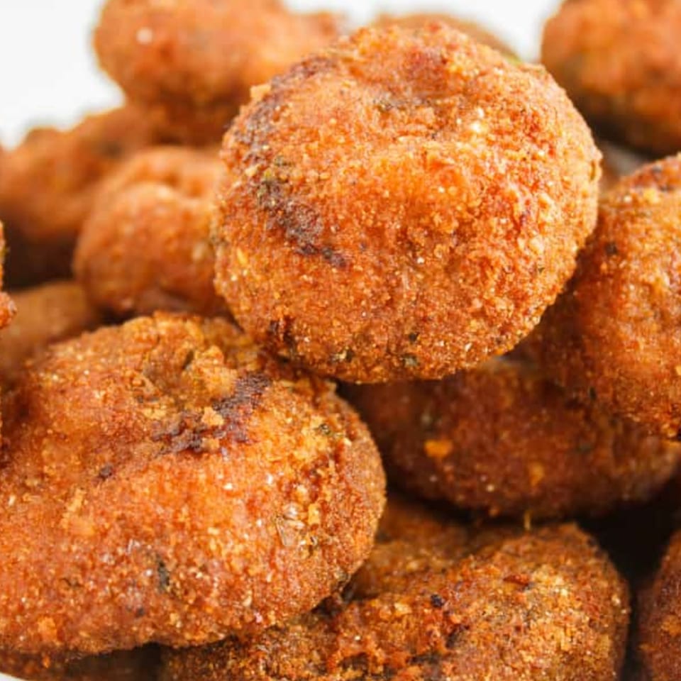 Close-up of golden-brown, breaded, fried hush puppies from Duffy's BBQ and Grill.
