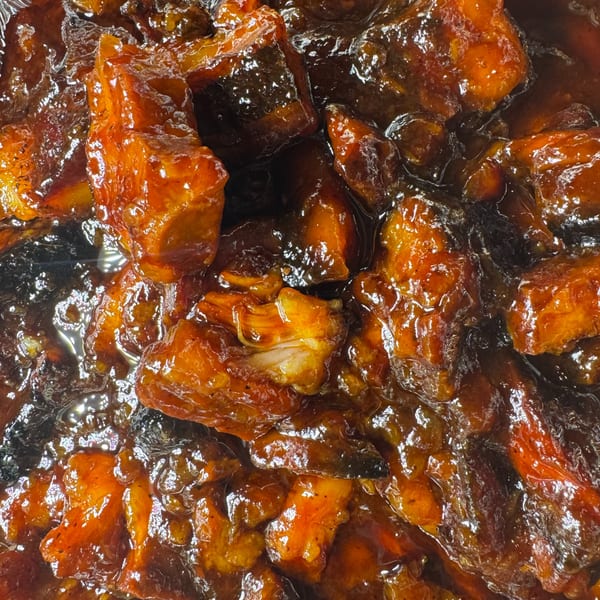 Close-up of glistening, saucy BBQ pork burnt ends from Duffy's BBQ and Grill.